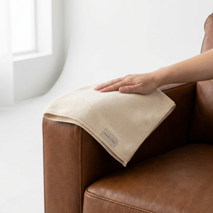 Aussie Glow microfiber buffing cloth — applied to leather couch